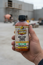Tradesman hand holding Jobsite Junkies Boot and Foot Powder on jobsite - peppermint foot powder for smelly work boots
